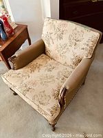 Front angled view of floral upholstered bergere armchair