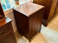 Front and side view of wooden bar cabinet