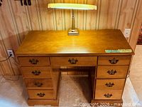 Front view showing eight drawers and brass-tone pulls
