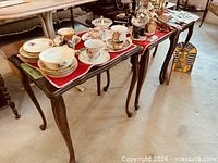 Largest nesting table with stacked china demonstrating top surface