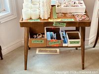 Front view of wood console table showing scalloped edge and tapered legs