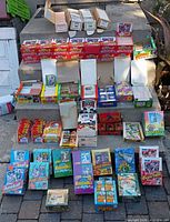 Wide shot of all trading card boxes, packs and loose cards displayed on outdoor steps