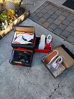 Four sneaker boxes open showing Nike, Adidas, Jordan and Vans pairs