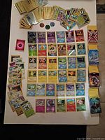 Full layout showing all Pokémon cards, coins and stacked deck sleeves