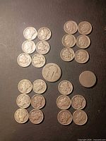 Full lot layout: 20 dimes in four vertical rows, two half-dollar coins centered and lower right