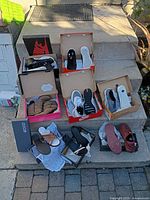 All nine pairs of shoes displayed in boxes on steps