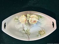 Top view of oval dish showing yellow rose design and handles