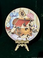 Front view of decorative plate showing artwork and gold rim