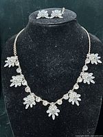 Full view of necklace on bust with earrings displayed