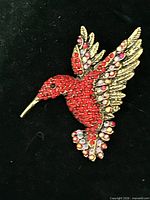 Front view showing red rhinestone hummingbird design
