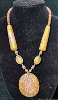 Full view of resin and wood bead necklace on bust