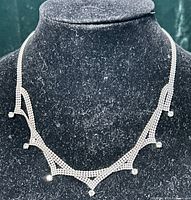 Necklace displayed on bust form front view