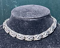 Full view of chunky linked necklace on display bust