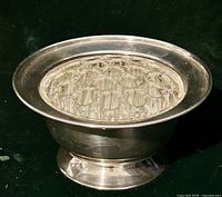Angled view of bowl showing pedestal base and glass frog