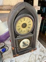 Front view showing full clock, dial and owl panel