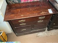 Front view of washstand showing drawers, door, and brass pulls
