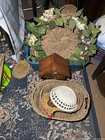 Overall view of baskets and birdhouse including shallow tray with greenery