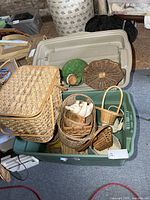 Two totes filled with various wicker baskets and trays showing sizes and styles