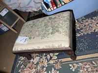 Oblique view showing upholstery pattern and wooden legs