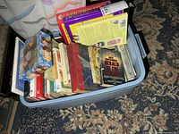 Overview of blue tote filled with books and small puzzle