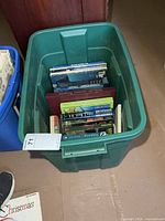 Top view of green tote filled with assorted books