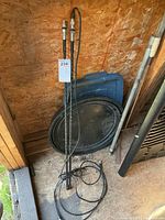 Full view of both CB antennas leaning against wall with cables coiled