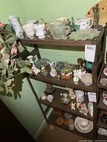 Full view of four-shelf unit showing mixed collectibles