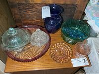 Group view of all coloured glass pieces on wooden surface