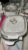Stacked square dishes topped with glass lids