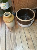 Both crocks side by side on wooden floor