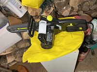 Left side view of Yardworks electric chainsaw showing guide bar and body