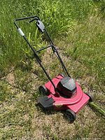 Full view of Sunbeam electric mower showing handle, deck, wheels