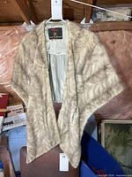 Full view of fur shawl hanging to show size and colour