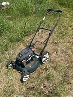 Full view of Yardworks gas mower in grass