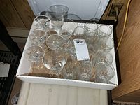 Cardboard tray containing assorted clear glasses