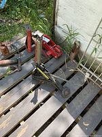 Group of jacks and stands on pallet outdoors