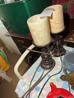 Pair of dark column table lamps with cream faux marble cylinder shades on tabletop