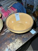 Top view of tan stoneware bowl showing interior glaze and hairline