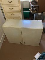 Front view of metal cabinet showing two doors and handles