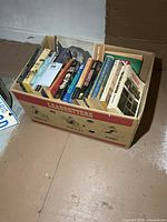 Full view of cardboard box marked Leadbetters holding the paperback books