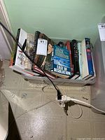 Entire plastic bin showing variety of books