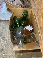 Box with mixed glass bottles showing overall quantity and colours