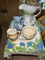 All four ceramic items on table