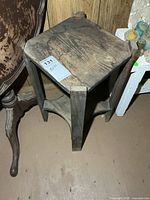 overall view of wooden plant stand showing top, legs and stretcher