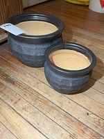 Both planters side by side showing size difference and exterior texture