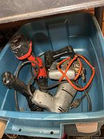 Overview of tote with multiple power tools—jigsaw, corded drill, three cordless drills