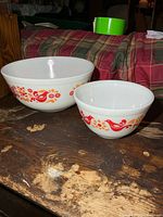 Side view of both Pyrex Friendship bowls showing pattern and size difference