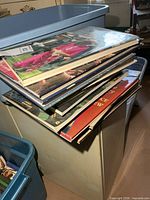 Stack of large royalty books on cabinet