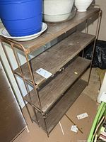 Front view of 4-tier shelf showing metal frame and shelves