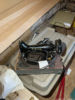 Singer sewing machine on base with pedal and cords